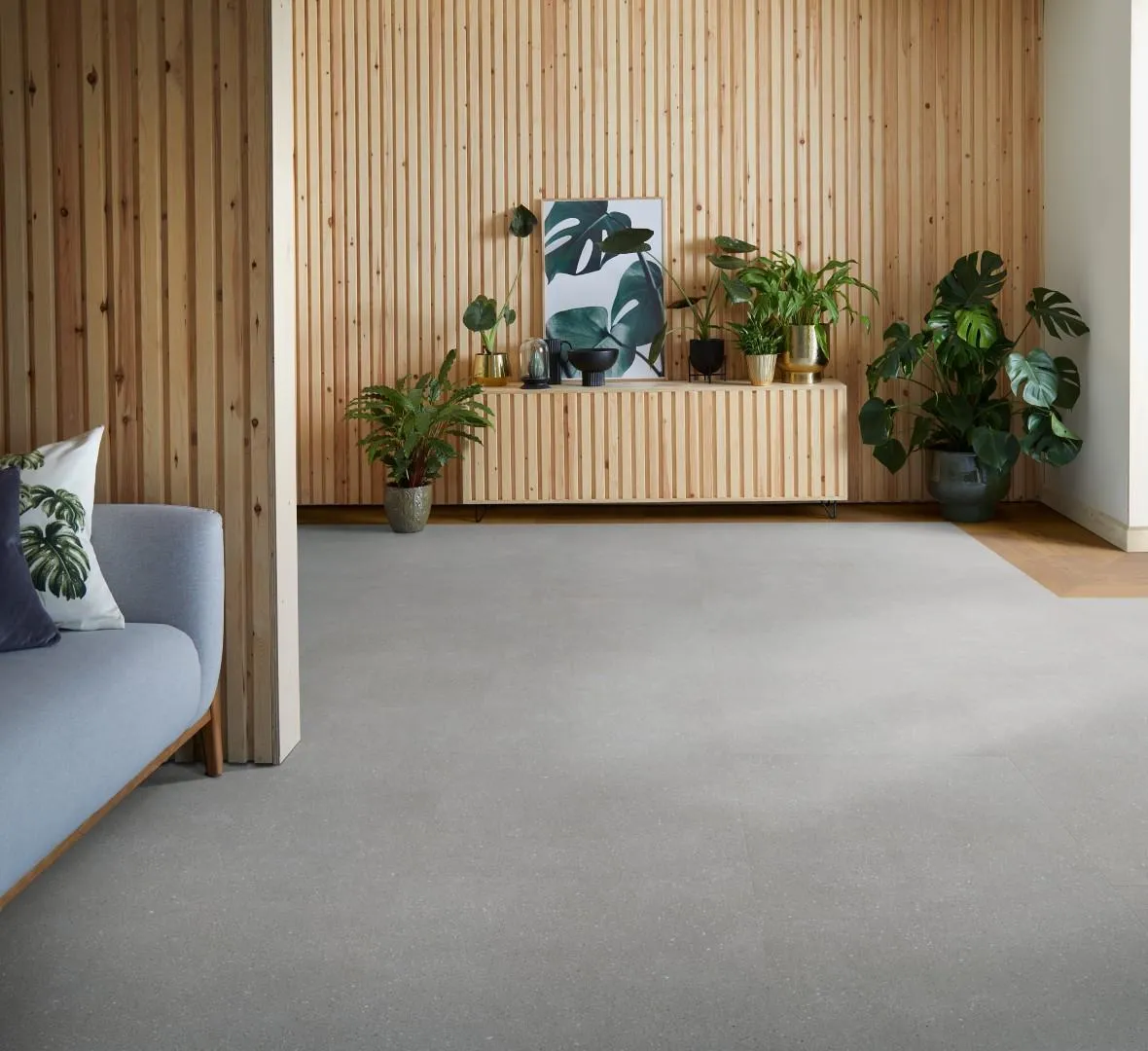 Industrial Dark Grey Concrete Look LVT Close-up of matte, deep charcoal grey Luxury Vinyl Tile (LVT) with a textured, subtle concrete or natural stone look.